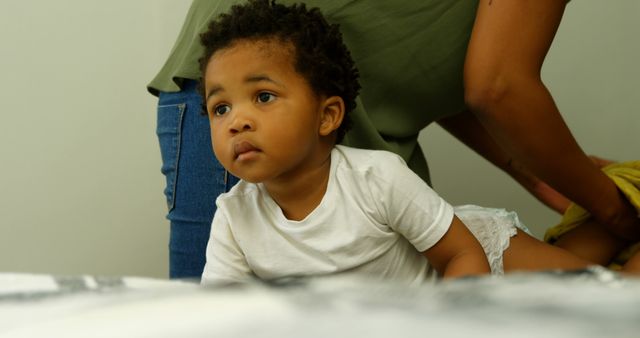 Curious Toddler with Parent During Diaper Change - Download Free Stock Images Pikwizard.com