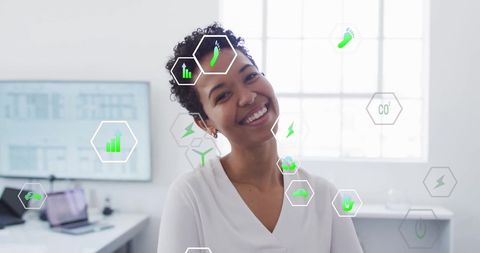 Eco-friendly businesswoman in tech-forward office with environmental icons