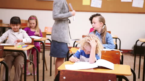 Teacher Distributing Papers in Classroom Setting