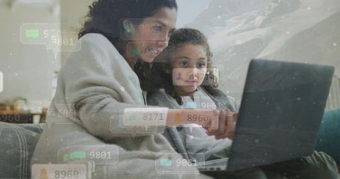 Mother teaching child online safety on laptop in cozy living room with digital alerts