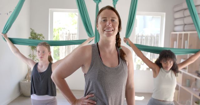 Women Practicing Aerial Yoga Indoors, Smiling and Confident - Download Free Stock Images Pikwizard.com