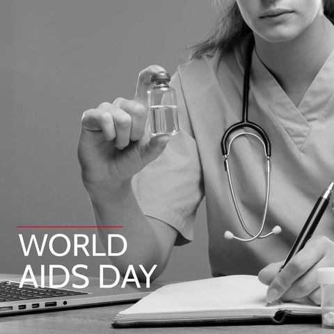 Caucasian female doctor holding medical vial for world aids day