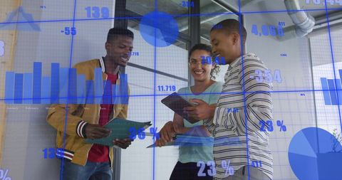 Diverse Business Team Analyzing Financial Analytics in Modern Office