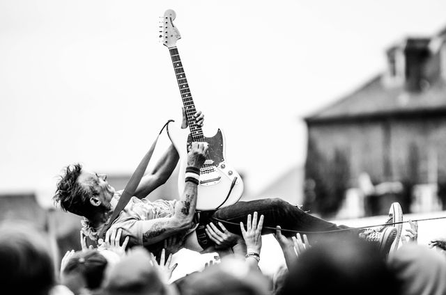Gray Scale Photo of Man Lifted by People Holding Stratocaster Guitar - Download Free Stock Photos Pikwizard.com
