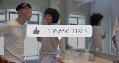 Young friends chatting at modern bathroom vanity with social media likes overlay