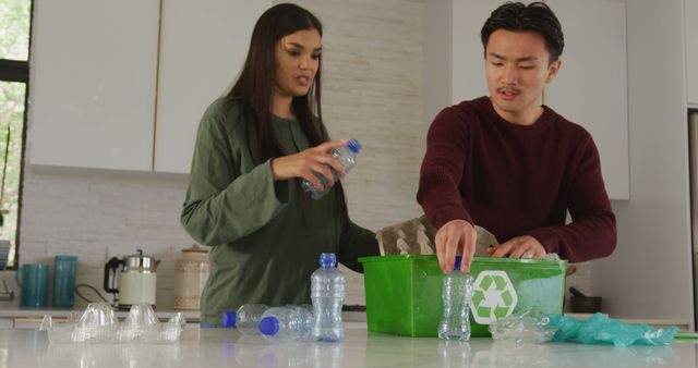 Couple sorting and recycling plastic bottles in modern kitchen, emphasizing importance of environmental care and teamwork. Perfect for illustrating eco-friendly practices, sustainable living, and household recycling efforts.