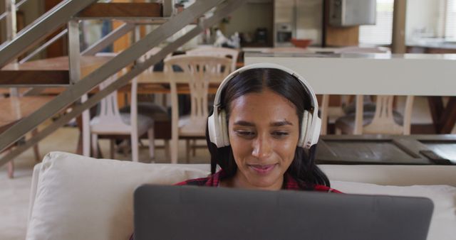 Young Woman Wearing Headphones Using Laptop at Home - Download Free Stock Images Pikwizard.com