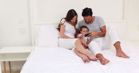 Family Bonding on Bed While Engaging with Smartphone - Download Free Stock Images Pikwizard.com