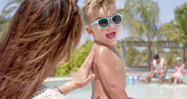 Mother Applying Sunscreen to Happy Boy by Poolside - Download Free Stock Images Pikwizard.com