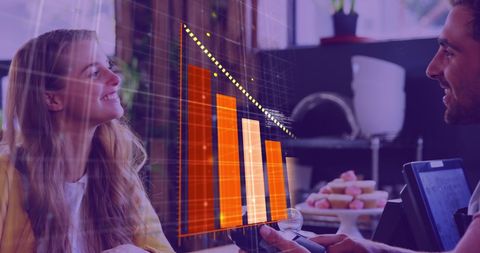 Caucasian Couple Analyzing Interactive Digital Bar Graphs on Tablet