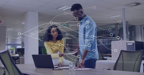 Colleagues Discussing Work in Open Plan Office with Digital Overlay