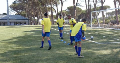 Soccer Players Master Dribbling Skills at Outdoor Training Session