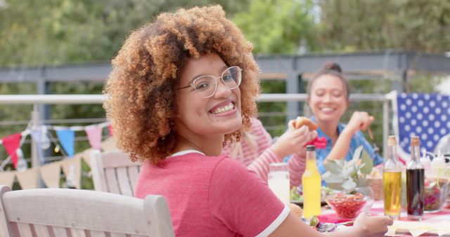 Young woman smiling at picnic with friends outdoors - Download Free Stock Images Pikwizard.com