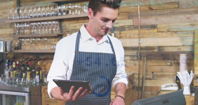 Young Barista Using Digital Tablet Behind Counter at Coffee Shop - Download Free Stock Images Pikwizard.com