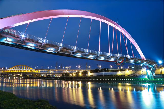 Modern Bridge Illuminated at Night Over Reflective River - Download Free Stock Photos Pikwizard.com