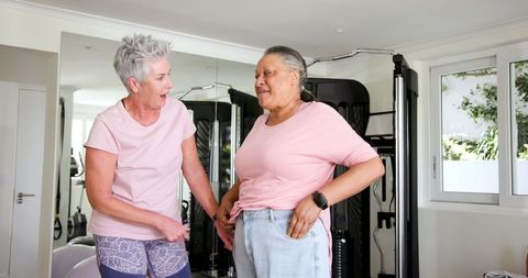 Senior Interracial Couple Exercising at Home Gym