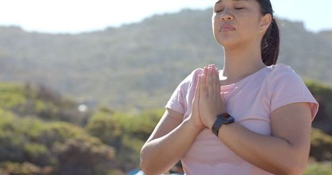 Woman embracing mindful meditation in mountain landscape