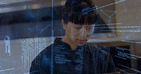 Asian engineer analyzing code on holographic interface in tech lab