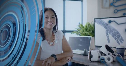 Asian Female Engineer with Holographic Interface in Modern Office