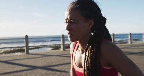 Exhausted Athlete Leaning Forward After Outdoor Jog by Ocean