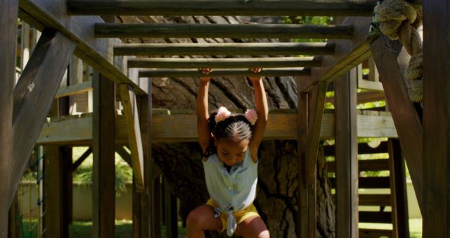 Young Girl Playing on Wooden Jungle Gym Outdoors - Download Free Stock Images Pikwizard.com