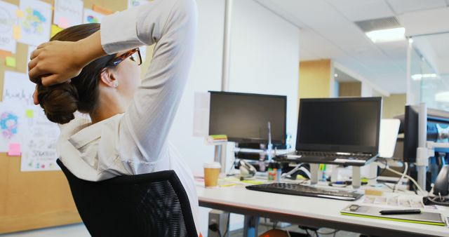 Young Woman Taking a Relaxed Break at Office Desk - Download Free Stock Images Pikwizard.com