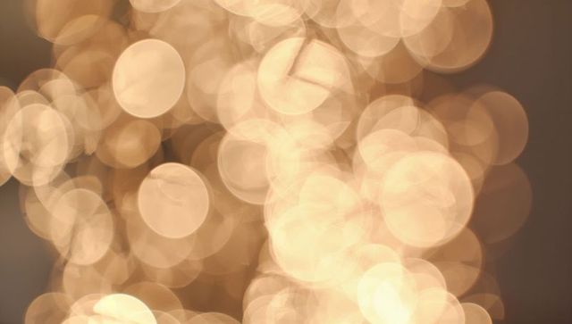 Warm golden bokeh lights creating soft layered glow and ambient circular orbs