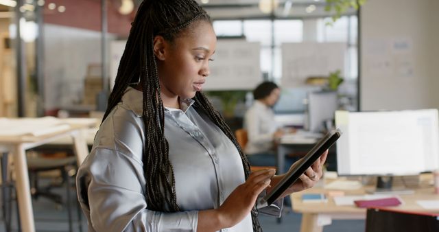 Focused African American Businesswoman Using Tablet in Office - Download Free Stock Images Pikwizard.com