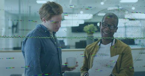 Colleagues reviewing printout while holding coffee in modern office with glitch overlay