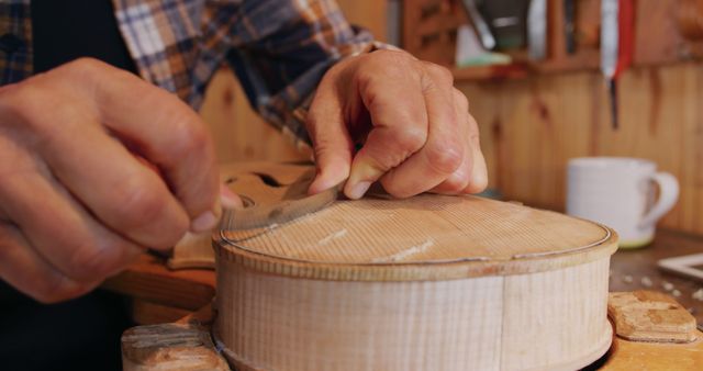 Craftsman Shaping Violin With Precision and Skill in Workshop - Download Free Stock Images Pikwizard.com