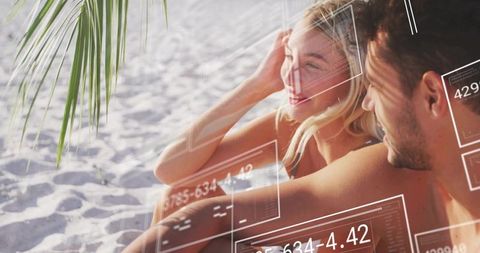 Couple Enjoying Tropical Beach with Futuristic Data Displays