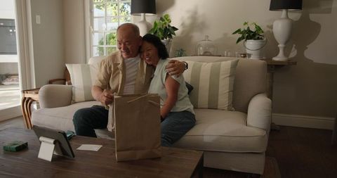 Senior Couple Celebrating Pregnancy with Gifts