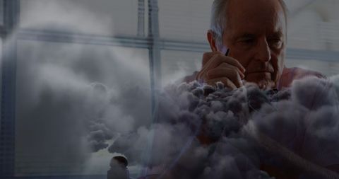 Pensive senior man overlaid with stormy clouds symbolizes mental struggle