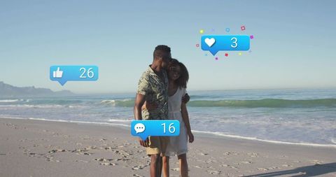 Couple kissing on sunny beach with social media like, comment and heart notifications