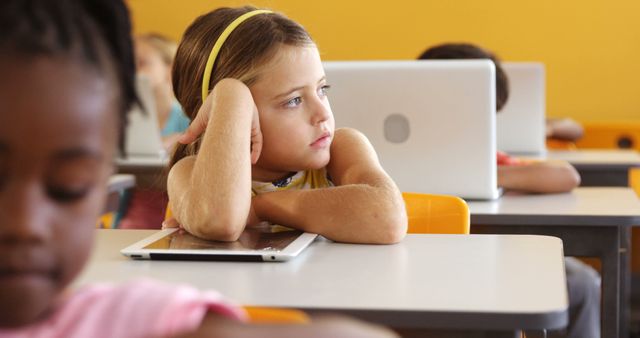 Thoughtful Girl with Tablet in Classroom - Download Free Stock Photos Pikwizard.com
