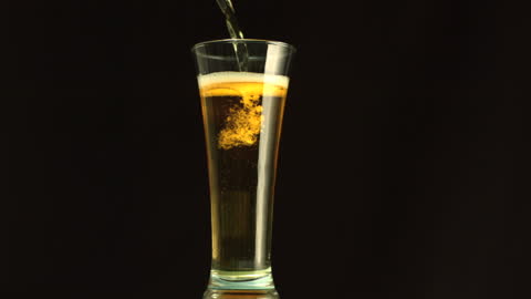 Refreshing Beer Pouring in Tall Glass