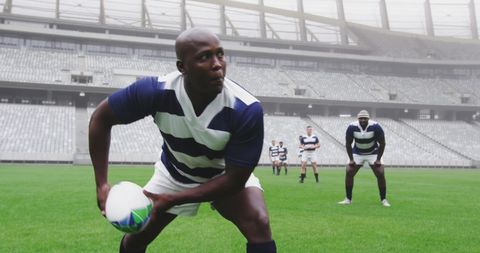 Focused Rugby Player Passing in Stadium with Teammates