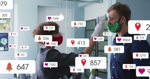 Masked nurse performing temperature check in office reception