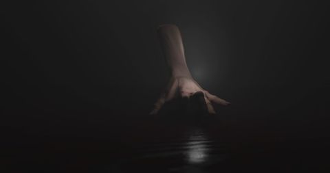 Eerie Hand Crawling in Dark Misty Environment