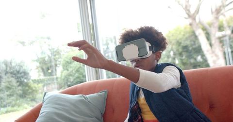 Boy Using VR Headset and Exploring Digital World