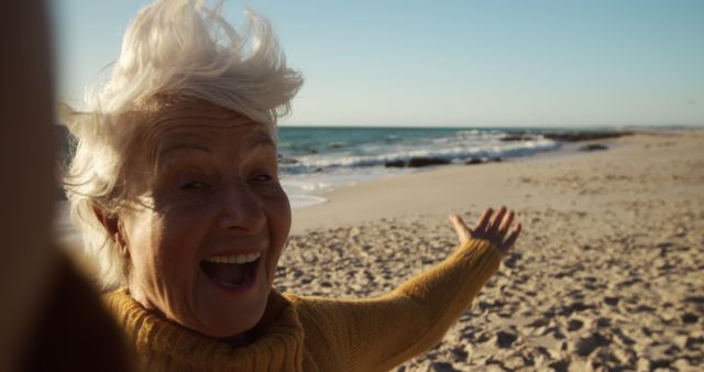 Senior Woman Enjoying a Windy Day at the Beach - Download Free Stock Images Pikwizard.com