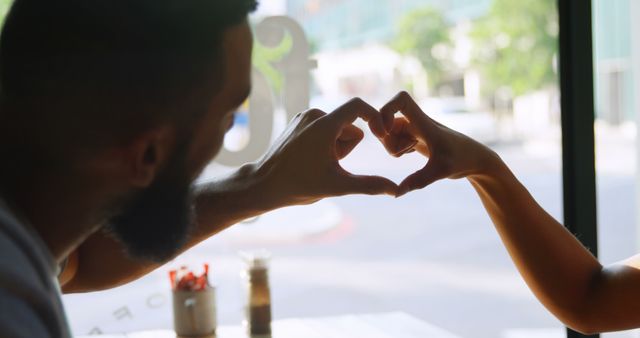 Couple Creating Heart Shape Bonding in Cafe - Download Free Stock Images Pikwizard.com