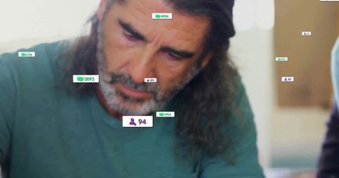 Man Analyzing Tablet with Data Overlays in Modern Workspace