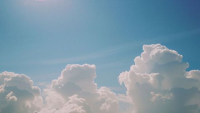 Billowing Cumulus Clouds Against Bright Blue Sky