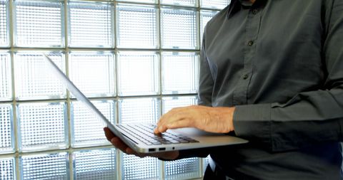 Caucasian Businessman Working on Laptop in Office Setting