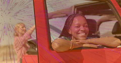 Joyful Women Enjoying Adventure in Red Off-Road Vehicle