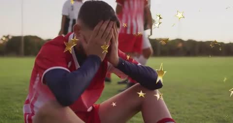 Soccer Player on Field Hands on Face after Match with Golden Stars