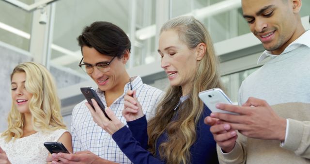 Diverse group using smartphones in modern office - Download Free Stock Images Pikwizard.com