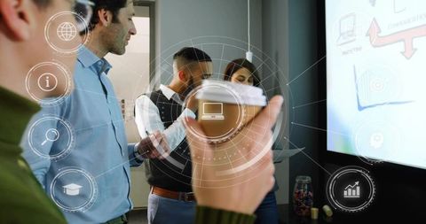 Team collaborating around digital presentation while holding coffee cup with ui overlay
