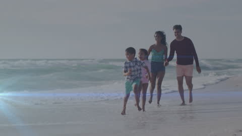 Happy Family Walking on Beach at Sunset with Light Trails